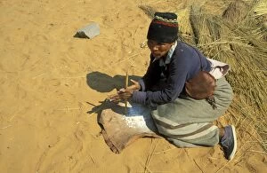 Bushmen Gallery: Namibia - A Kung Bushman / San woman drills holes