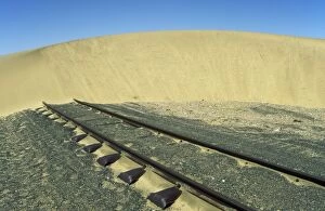 Namibia - rails and shifting dune (barchan dune)