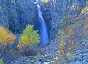 Njupeskaer waterfall - colourful decorated gorge and cliffs of Swedens highest waterfall in autumn