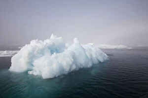 Norway, Svalbard, Iceberg floating in still