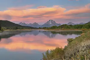 Sunrise Prints: Orange clouds and Mount Moran reflected in still waters of the Snake River at Oxbow Bend at sunrise