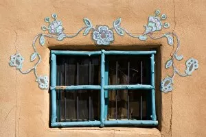 Ornate Window - turquoise painted window mounted in an adobe style building