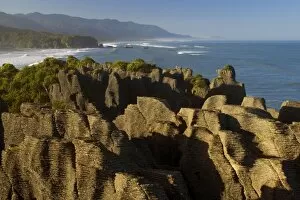 Images Dated 19th February 2008: Pancake Rocks famous flat limestone rock formations at Punakaiki with rainforest-clad coastline