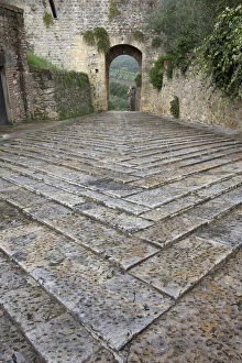 Pattern in stones on street and arched walkway