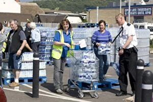 People collecting free bottled water from Tesco car park