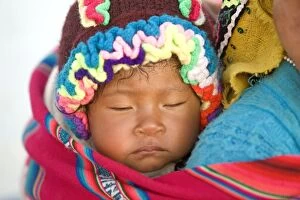 Peruvian child sleeping on mothers back - near