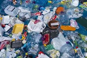 Plastic garbage floating in the ocean. Unlike