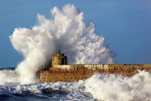 Piers Prints: Portreath - wave breaks over pier in storm - Cornwall - UK
