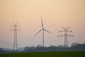 Power pole and wind turbine in sunset - Germany