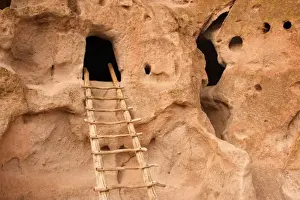 Pueblo Ruins - cave dwelling in Frijoles Canyon - wooden ladders lead into the cave by hand carved openings - these ruins were occupied for nearly 500 years until the late 1500s - Bandelier National Monument - Jemenez Mountains - New Mexico - USA
