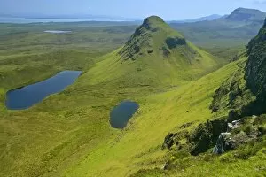 The Quiraing landscape - lakes and rolling velvet green slopes sprinkled with basaltic spikes of rock and cliffs