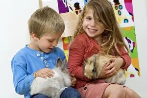 Rabbits - being cuddled by two young children