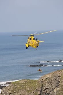 RAF helicopter air sea rescue - hovering over rocks