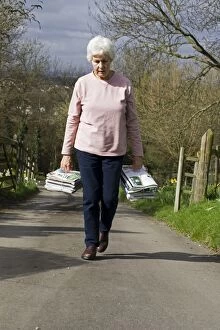 Bundles Gallery: Recycling - woman carrying bundles of magazines