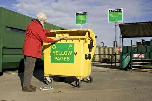 Recycling - Woman recycling Yellow Page directory