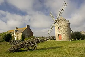 Cart Prints: Restored French windmill with old wood cart in foreground near Cherrueiux Brittany France