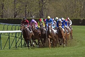 Riders and Racehorses galloping around racecourse