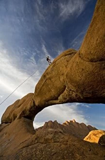 Rock Climber - absailing a rock arch