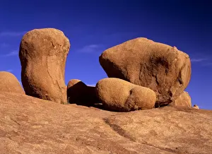 Weathered Prints: Rock marbles weathered rock formations of red granite Pandok Mountains