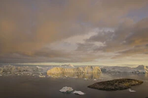 Images Dated 23rd April 2009: rocky island and large icebergs at midnight