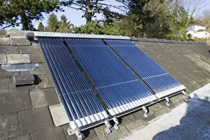 Green Energy Prints: Roof mounted Vaillant aurotherm evacuated tube solar collectors installed on slate roof Cotswolds UK