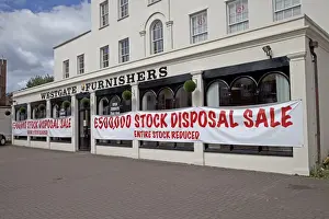 Shops Prints: Sale notices in furnishing shop window offering big discounts - Cheltenham UK