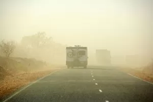 Sandstorm - a hugh sandstorm sweeps over a road in the outback. Cars are almost invisible because of the dense sand