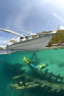Scuba Diver - beneath dive boat to explore a timber