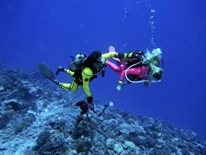 Two Scuba Divers - Camerman and his female model