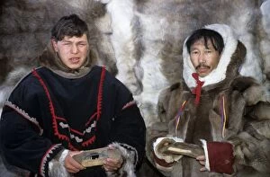 Selkup men in traditional clothes, holding traditional