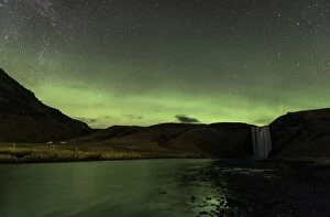 Skogafoss Waterfalls at night with reflection of