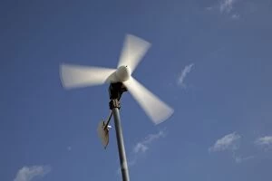 Small wind turbine against blue sky