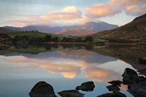 Snowdon at first light with a layer of cloud with reflections in Llynau Mymbya - November