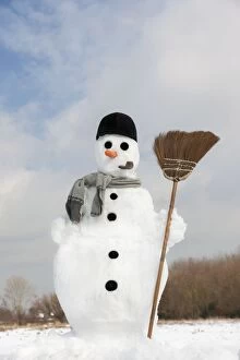 Snowman - with broom in snow landscape