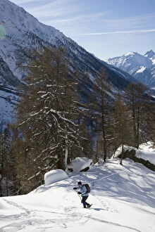 Snowshoeing in winter landscape in the Loetschental
