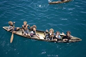 Solomon Islands children in canoe