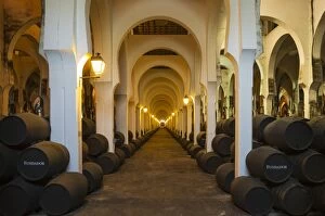 Stacked oak barrels in the wine cellar La Mezquita at
