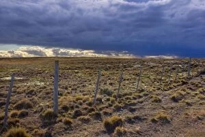 Images Dated 7th March 2010: Storm Clouds - dark storm clouds over steppe and fence