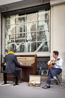 Artist Gallery: Two street buskers playing on a sidewalk