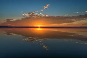 Reflected Prints: Stunning colors of sunrise and clouds reflected on Lake Hancock from Circle B Bar Preserve