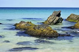 Summer beach - blue sea and rocks at beach of Scousburgh Sands