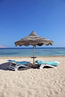 Middle East Gallery: Summer holiday beach umbrella by the sea and sun lounger