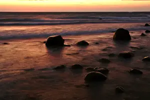 Inspiring Prints: Sunrise at sea beach with boulders and approaching waves Moen Peninsula, Denmark