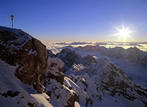 Sunrise on Zugspitze - view from highest mountain of Germany with summit cross at sunrise