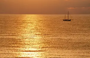 Sailing Prints: Sunset - over sea with small boat