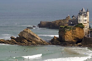 Surfing Cote de Basque below a castle in