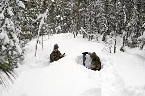 Taking a snow depth measurement in a boreal forest