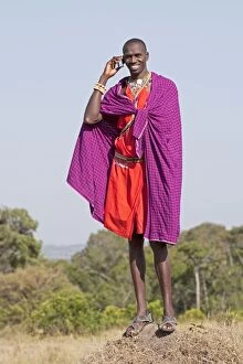 Images Dated 9th January 2009: Tall Maasai man wildlife guide using mobile phone