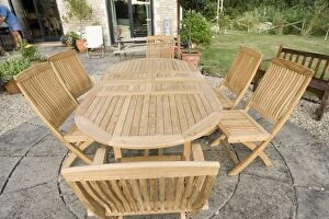 Teak garden table and chairs on patio, Cotswolds, UK