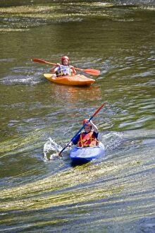 Teenage boys paddling canoes down River Wye, Lower